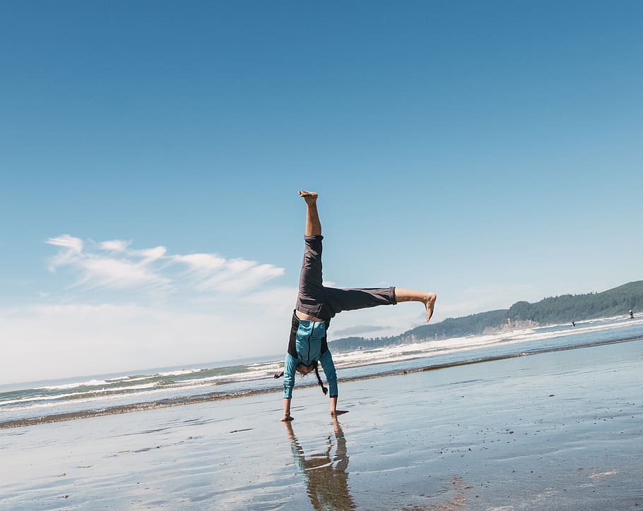 man doing a stunt on beach, sky, full length, lifestyles, one person HD wallpaper