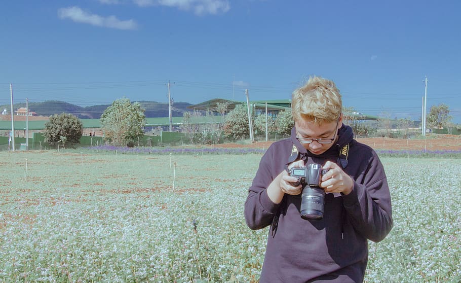 Man Holding Black Dslr Camera Under Blue Sky, clouds, crops, daylight HD wallpaper