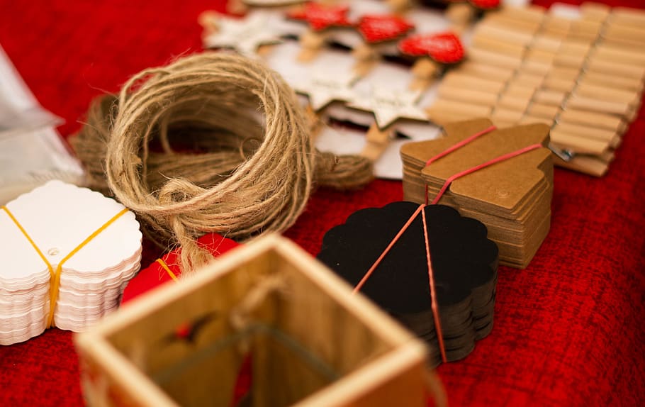 assorted art crafts on red textile, color, pincer, clothespin HD wallpaper