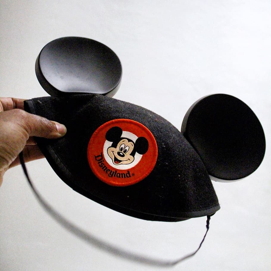 person holding Mickey Mouse cap, human hand, human body part HD wallpaper