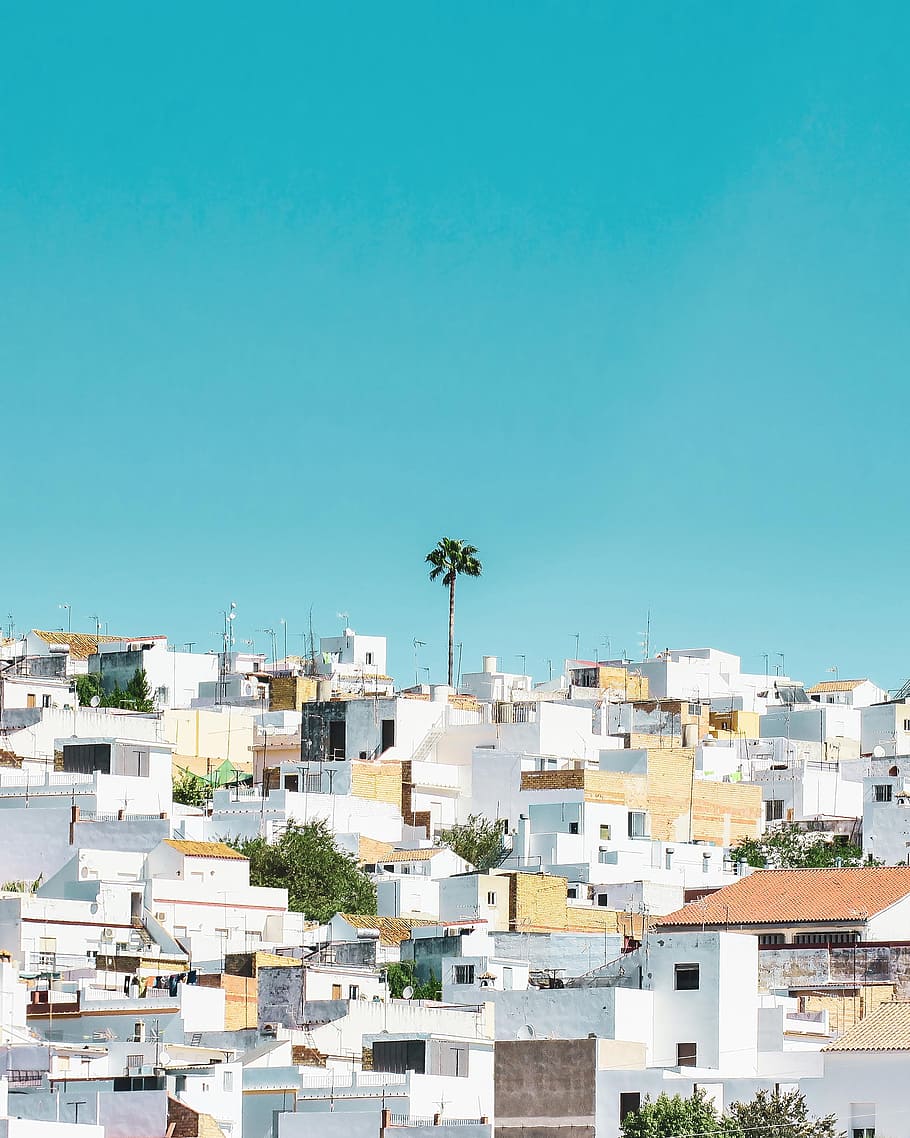 white and brown concrete houses under blue sky during daytime HD wallpaper