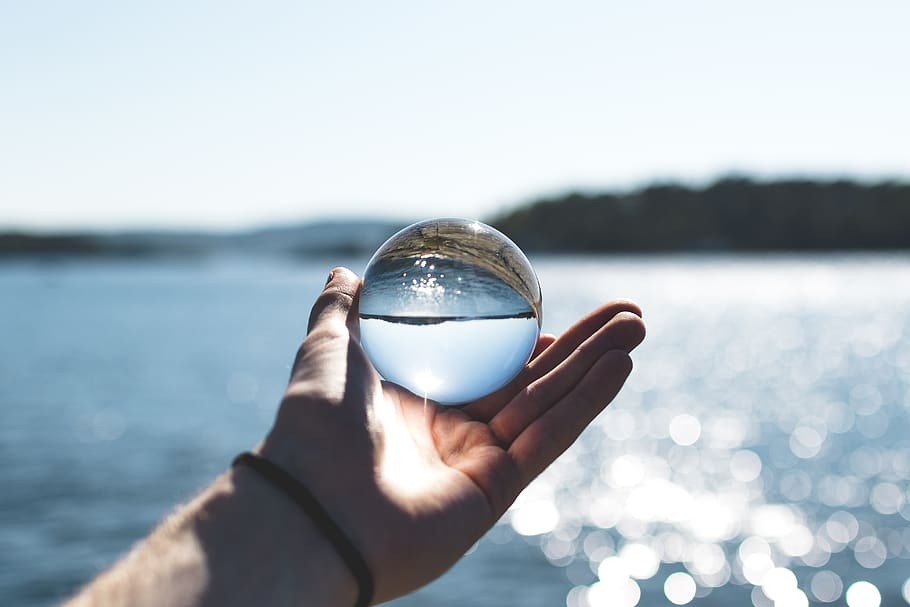 Selective Focus Photography of Person Holding Water Bubble, reflection HD wallpaper