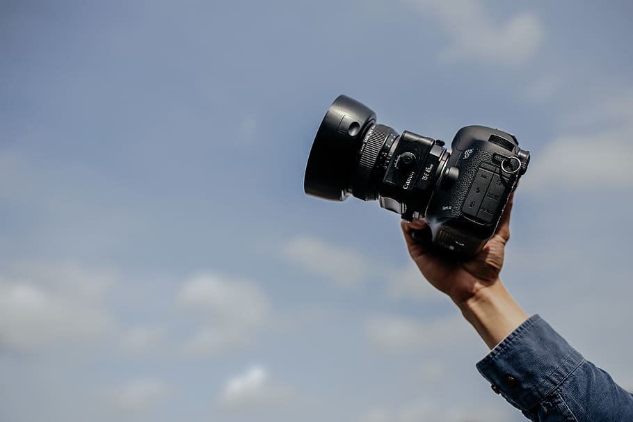 man using his black DSLR camera, photography themes, camera - photographic equipment HD wallpaper