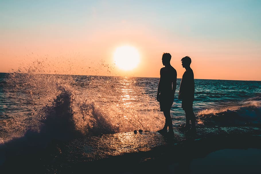 Two Men Standing on Seashore, backlit, beach, blue waters, dawn HD wallpaper