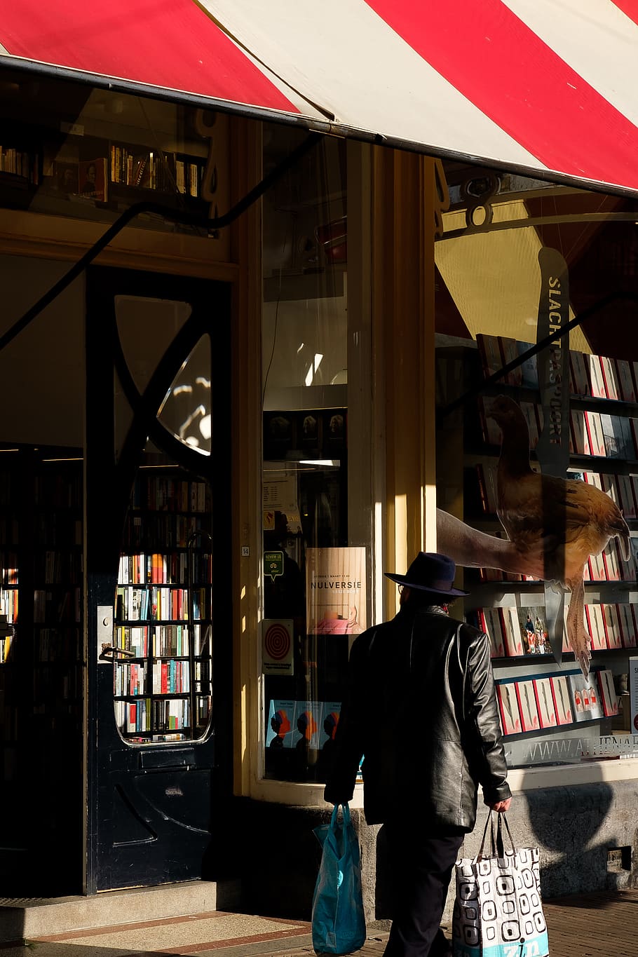 man standing beside store facade, furniture, indoors, shop, bookstore HD wallpaper