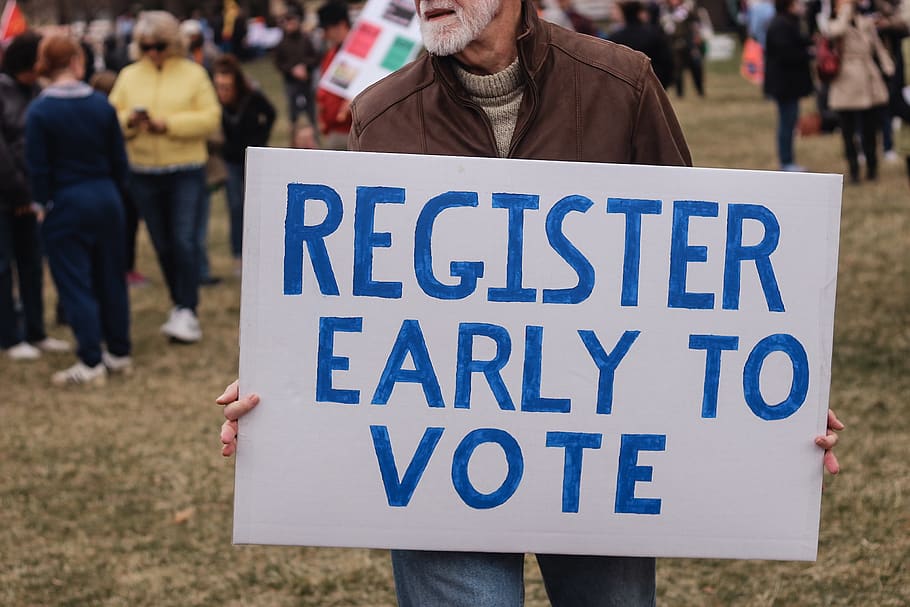 person holding a register early to vote sign, people, human, crowd, HD wallpaper