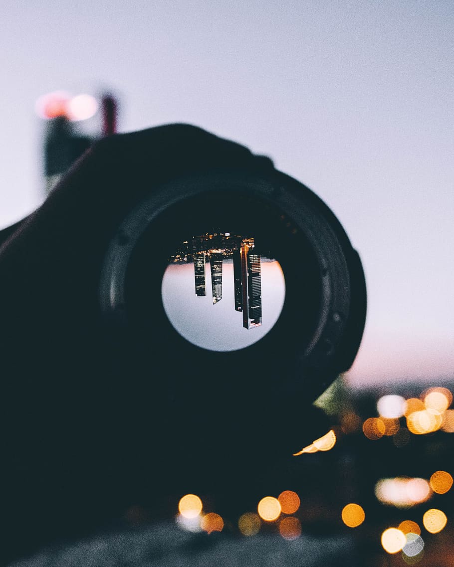 person holding round black lens, city, upside down, view, building HD wallpaper
