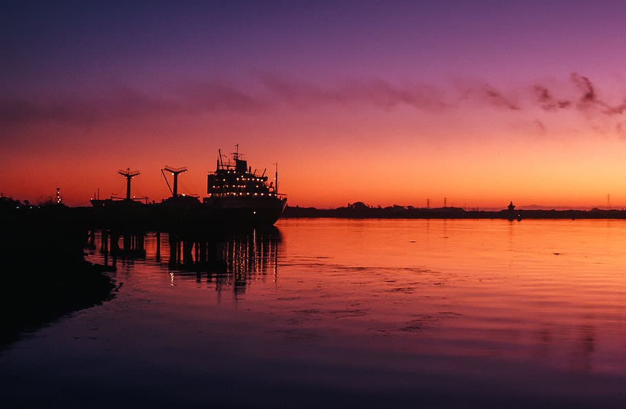 Cranes and transport ship docked at harbor during sunset, bay, HD wallpaper