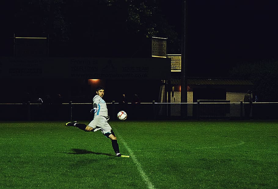 Person Kicks Soccer Ball in Field, action, athlete, dark, evening, HD wallpaper