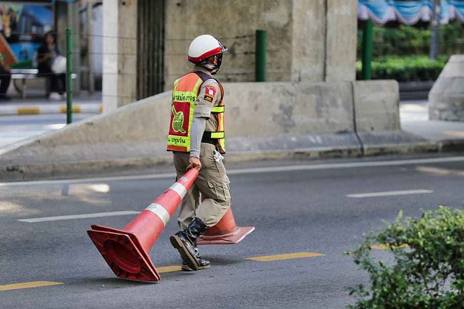 man pulling parking cones along road, helmet, clothing, apparel HD wallpaper