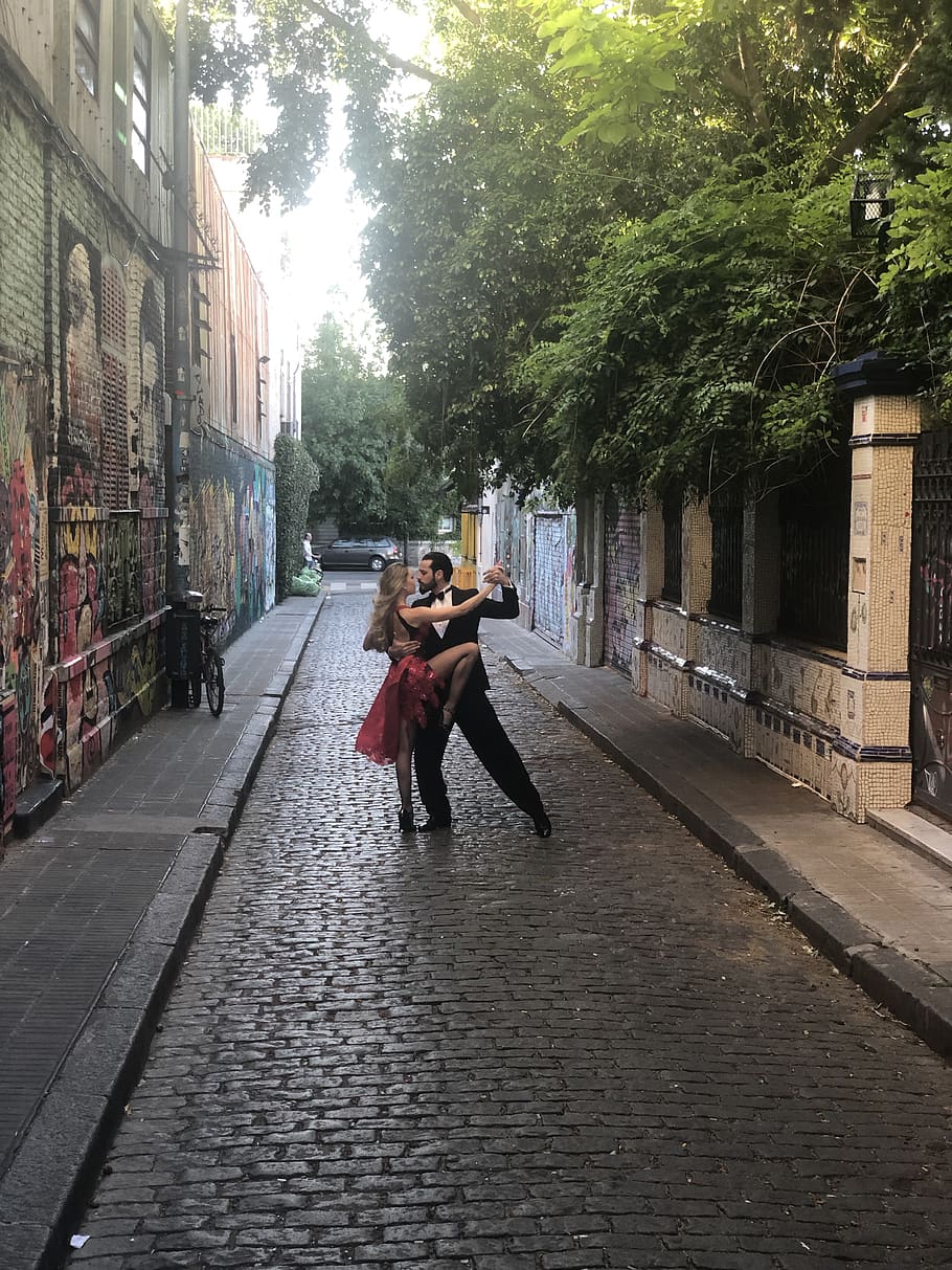 Man and Woman Dancing in Middle of Alleyway, cobblestone street