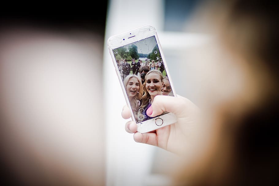 Selective Focus Photo of Gold Iphone 6 Displaying Two Women Taking Selfie HD wallpaper