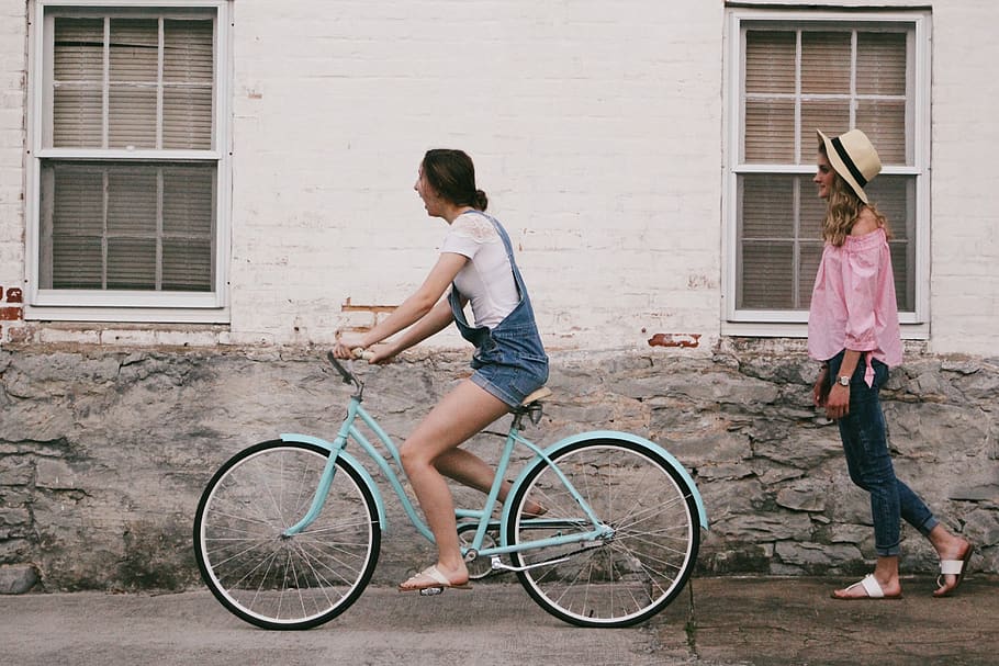 Woman Riding on Teal Cruiser Bike Near Woman Wearing Pink Long-sleeved Shirt HD wallpaper