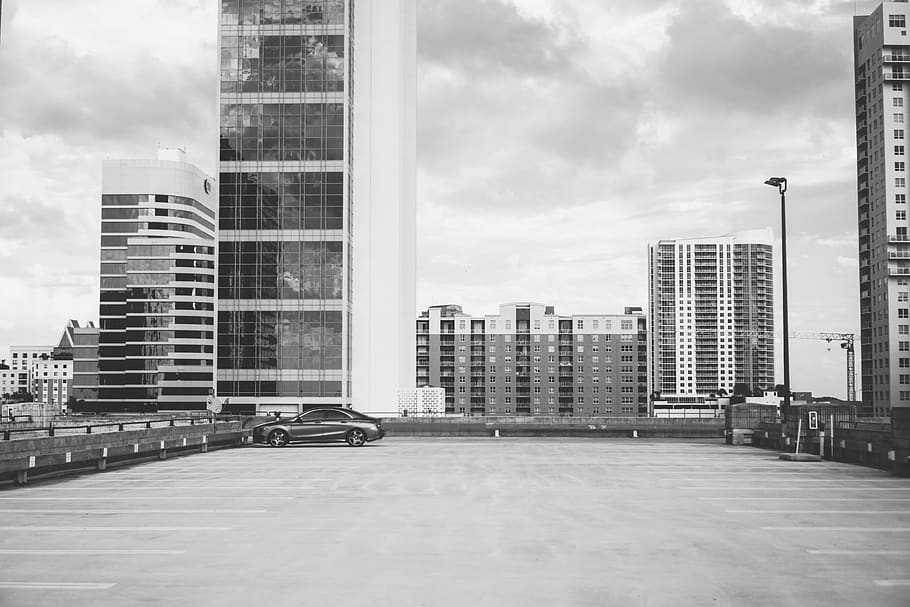 HD wallpaper: grayscale photography of vehicle parking with high-rise  building background | Wallpaper Flare