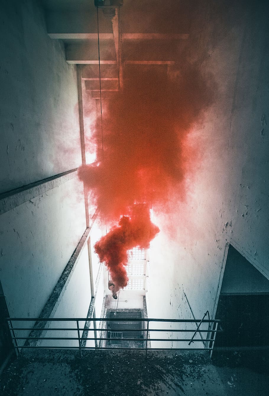 low angle view of man sprays red smokes inside building, visual HD wallpaper