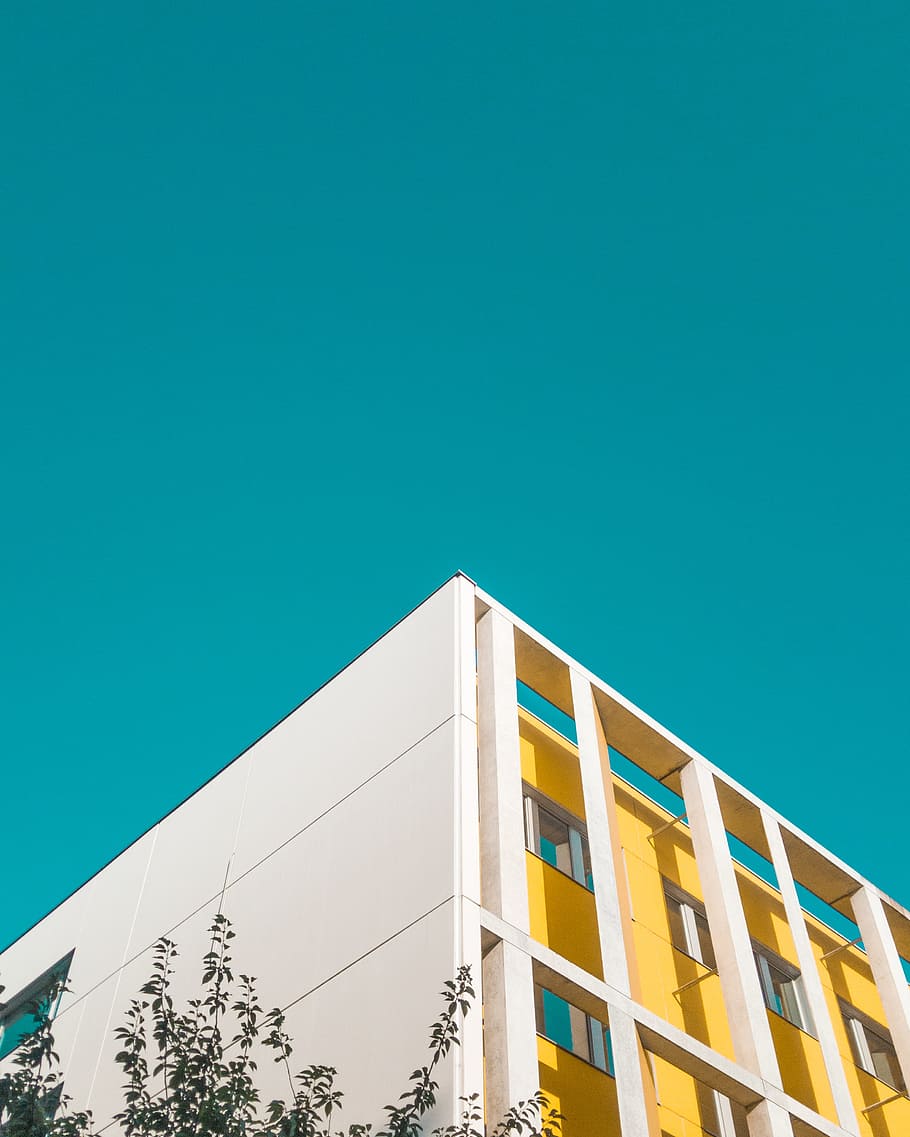low angle photography of white and yellow concrete building, sky HD wallpaper