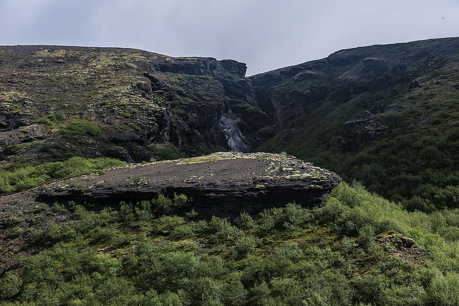 Photo of Mountain Covered Green Grass Under White Sky, cliff HD wallpaper