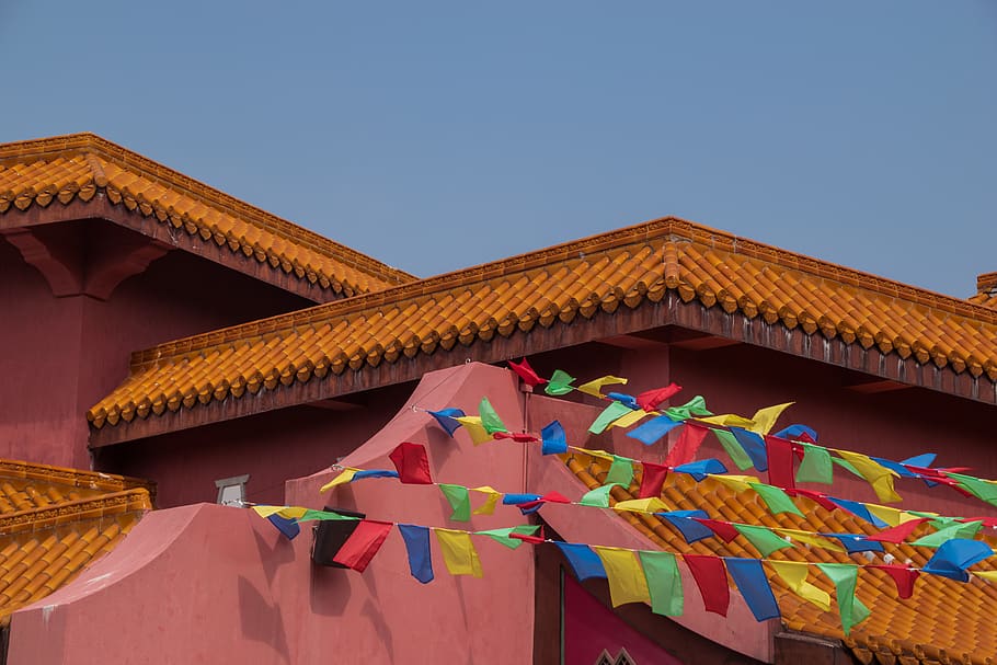 assorted-color buntings ties on roof of building under gray skies, HD wallpaper