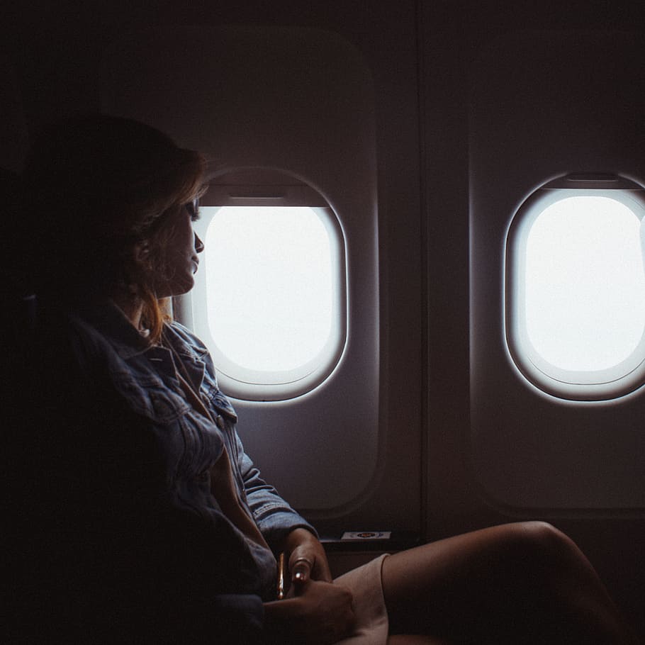 woman sitting inside airliner, person, window, glass, plane, aeroplane