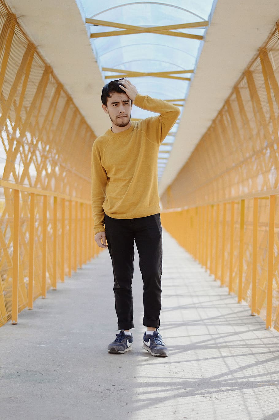 man standing on bridge while touching his head, shoe, clothing HD wallpaper