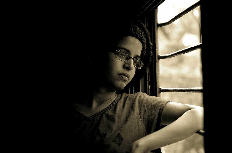 woman looking out through window, person, train, arm, travel