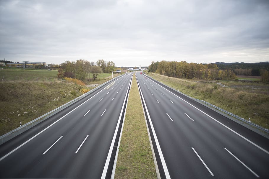 Two Grey Concrete Roads Between Green Grasses, asphalt, clouds HD wallpaper
