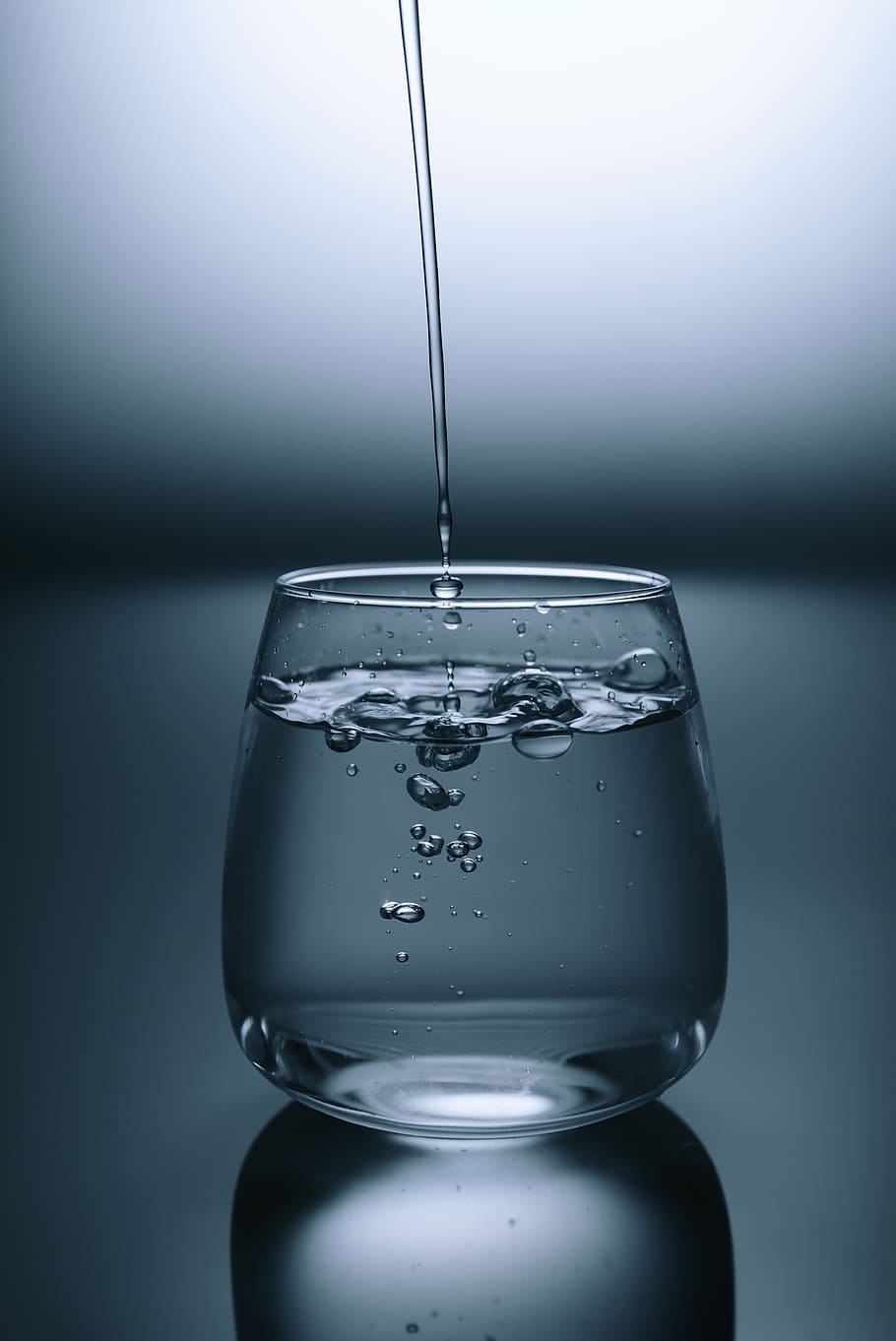 clear drinking glass on gray surface, water, studio shot, motion HD wallpaper