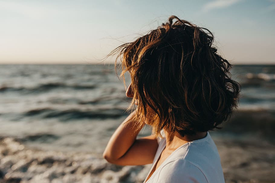 selective focus photography of woman near shoreline, portrait HD wallpaper