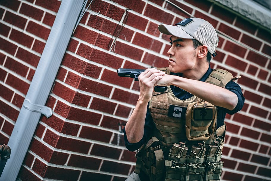 man holding pistol, human, person, people, brick, canada, toronto HD wallpaper