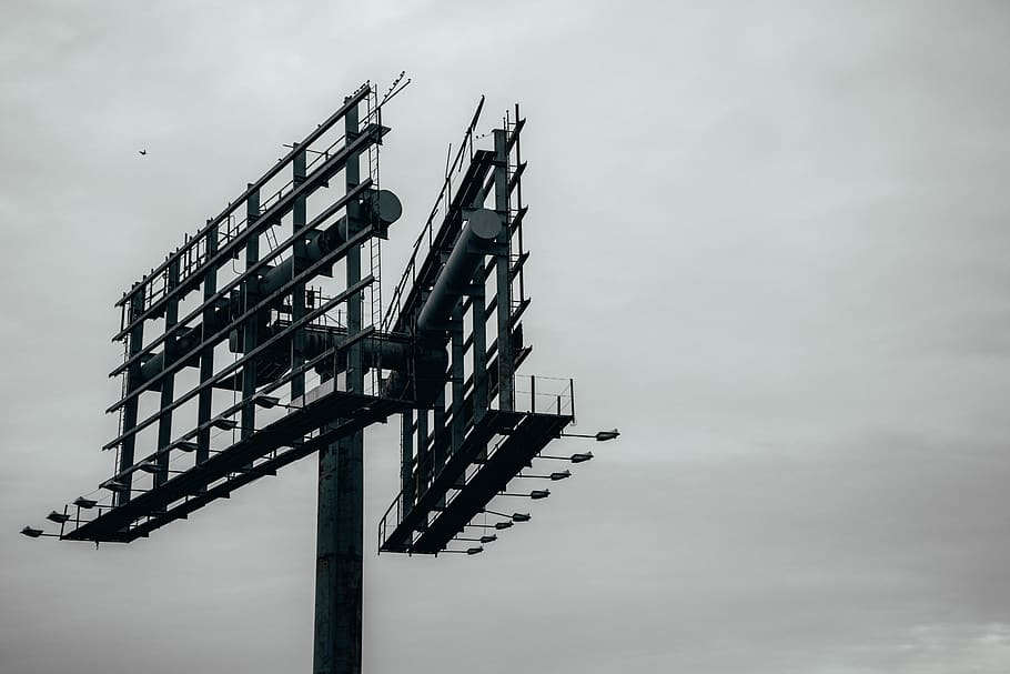grayscale photography of metal billboard, advertisement, construction crane