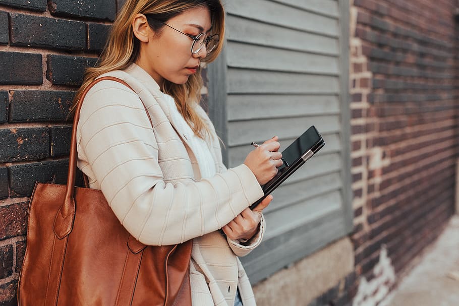 woman leaning on wall while using tablet, wireless technology HD wallpaper
