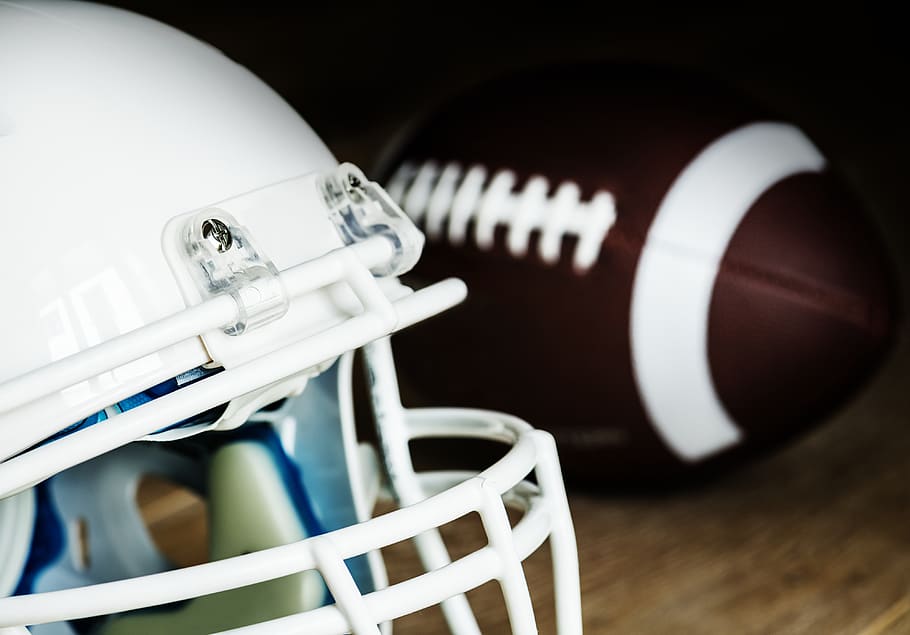 White American Football Helmet and Pigskin Ball, background, blurred background