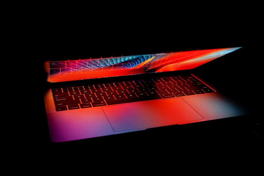 turned-on MacBook, black background, no people, technology, studio shot HD wallpaper