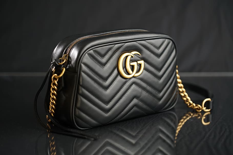 black Gucci leather shoulder bag, single object, studio shot
