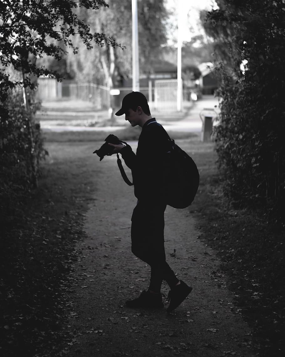 man holding camera while standing on path, people, person, human HD wallpaper