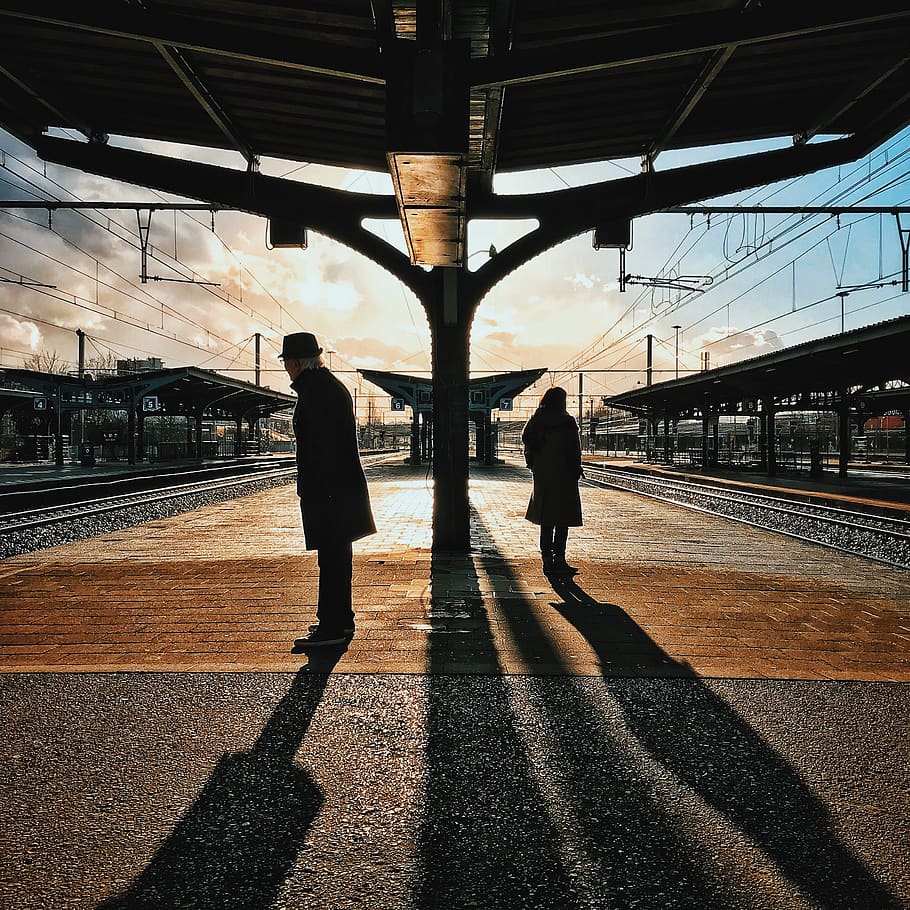 Man and Woman Silhouette Standing on Brown Ground at Daytime HD wallpaper