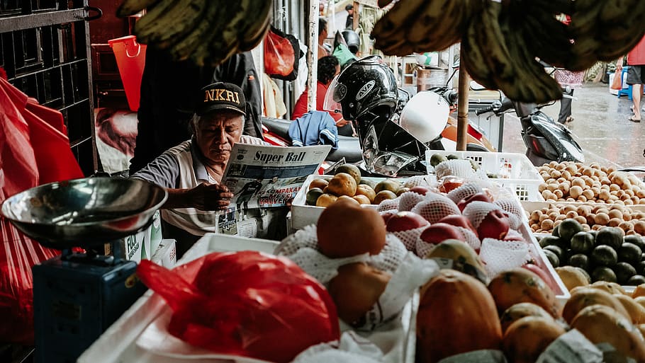 man reading newspaper with stalls, apparel, helmet, clothing, HD wallpaper