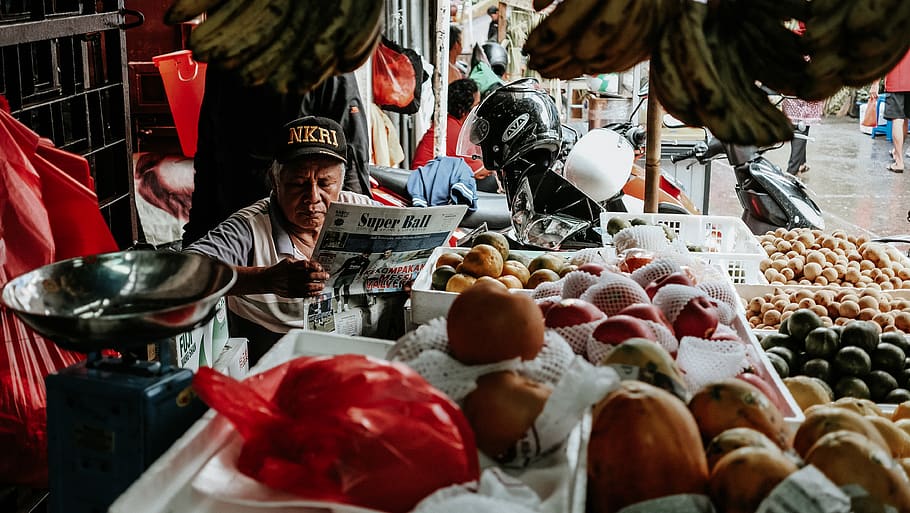 man reading newspaper with stalls, apparel, helmet, clothing HD wallpaper