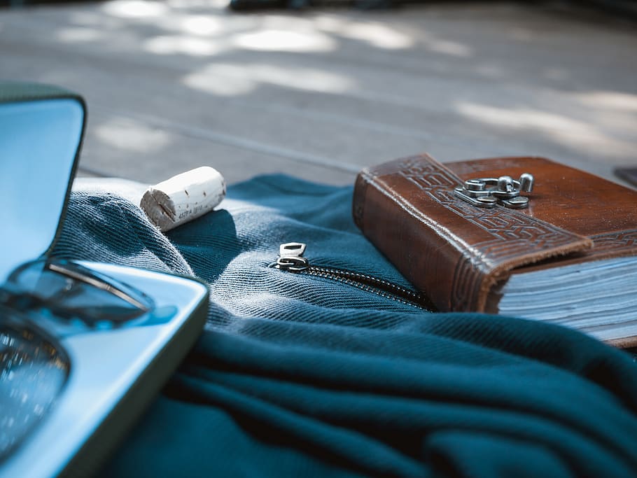 brown booklet on blue fabric surface, statues, stationary, flatlay HD wallpaper