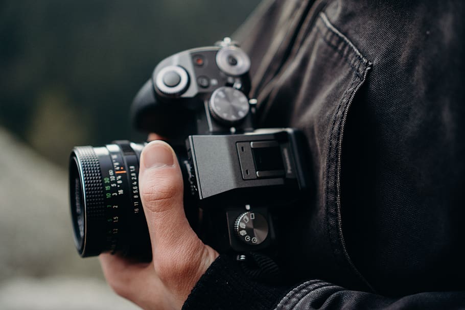 black DSLR camera, electronics, hand, jacket, tech, technology HD wallpaper