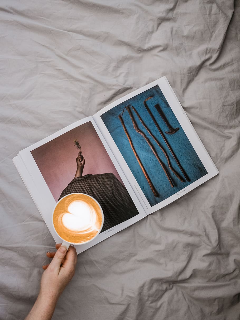 person holding mug of cappuccino on open magazine, human, wood, HD wallpaper