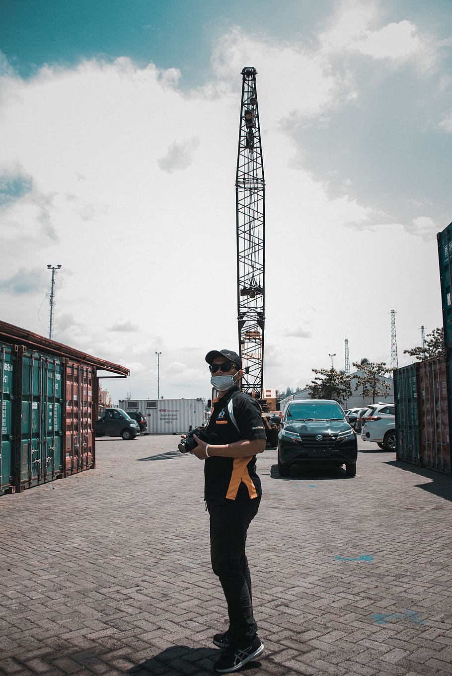 Man Standing Holding Camera , crane, person, architecture, built structure HD wallpaper