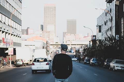 man standing in between road, person, back, human, people, city HD wallpaper
