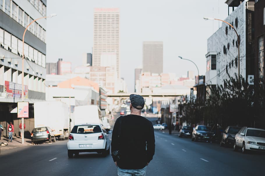 man standing in between road, person, back, human, people, city HD wallpaper