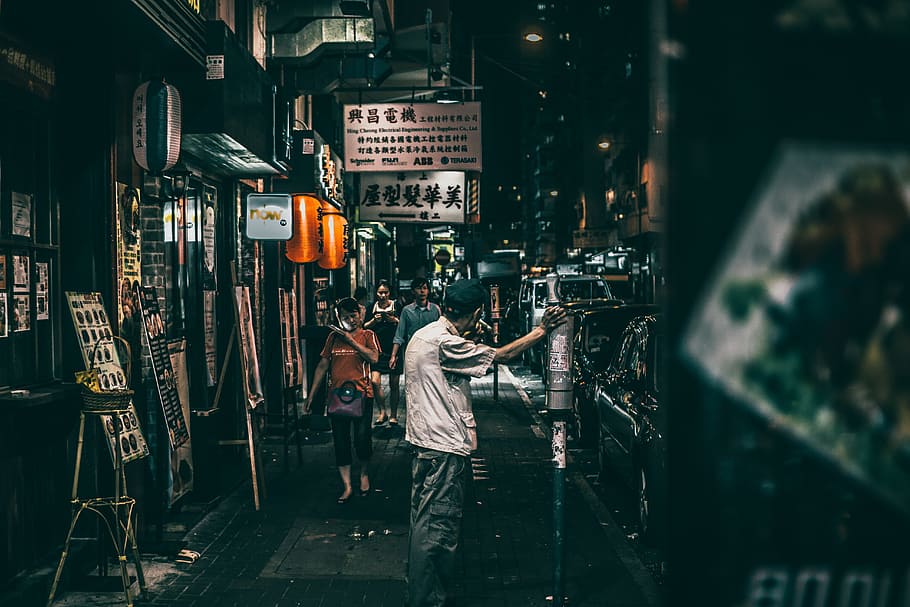 people on street between stores, nightlife, person, city, man