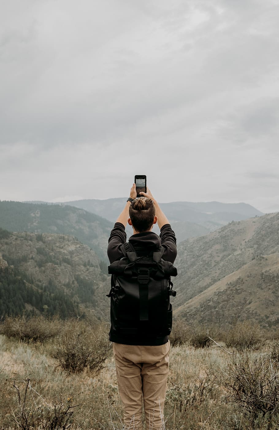 man standing and capturing hills, mountain, rear view, technology HD wallpaper