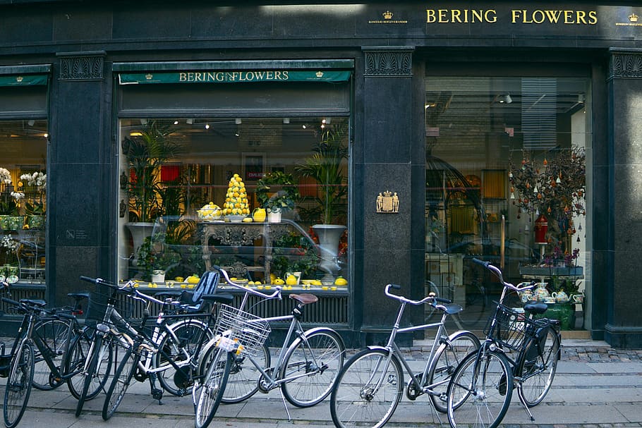 Several Assorted-color Bikes Parked in Front of Bering Flowers Facade, HD wallpaper