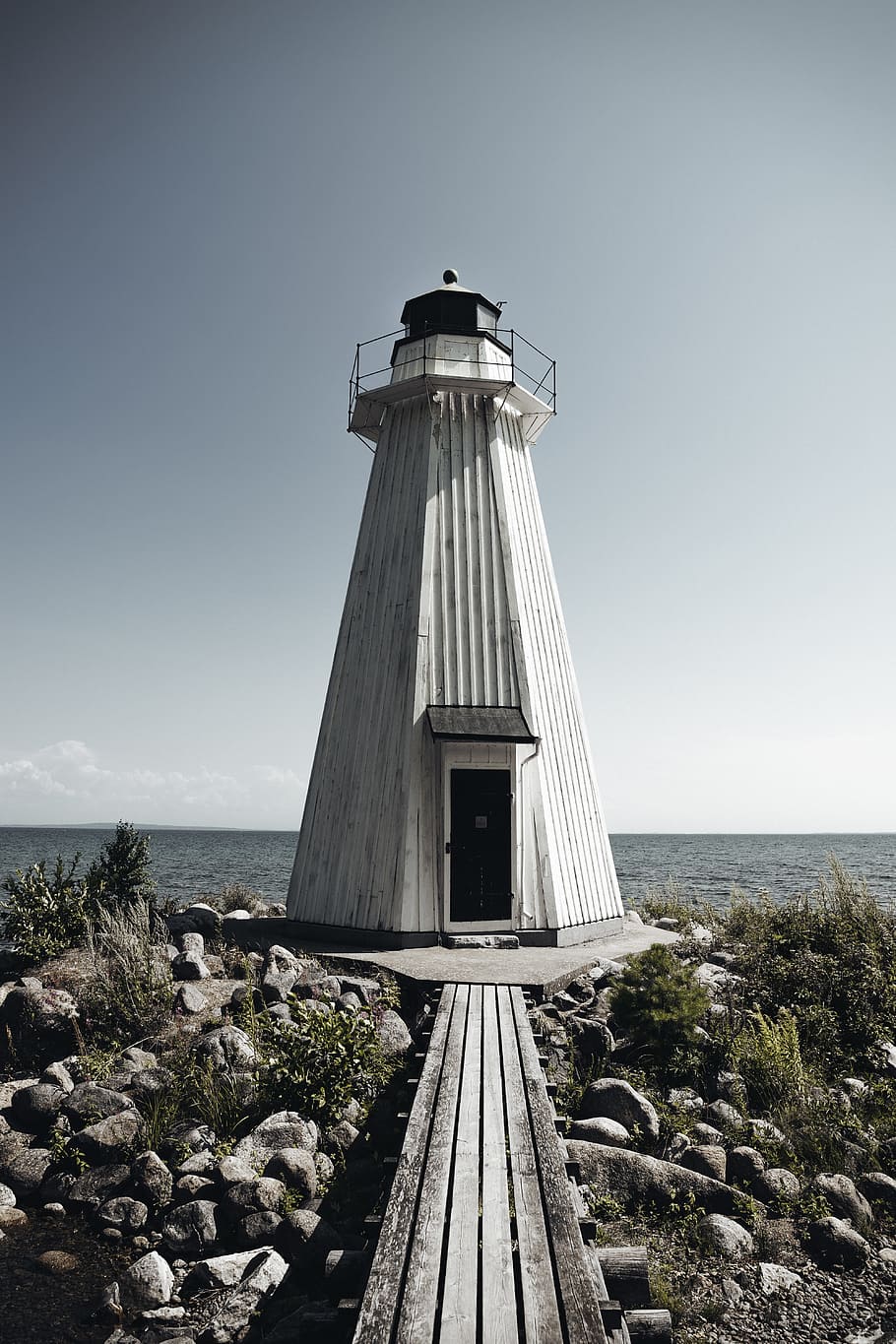 white and black lighthouse, building, water, pier, dock, stones HD wallpaper
