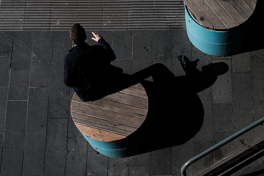 man sitting on round bench, one person, real people, full length HD wallpaper