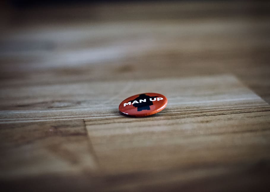 round red and black man up pin back button, badge, wood, bokeh HD wallpaper